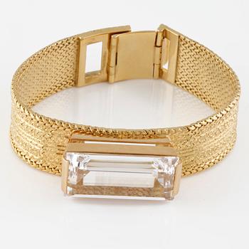 ARMLÄNK, 18K guld med fasettslipad vit syntetisk spinell, importstämplad. Vikt 68,9 gram.