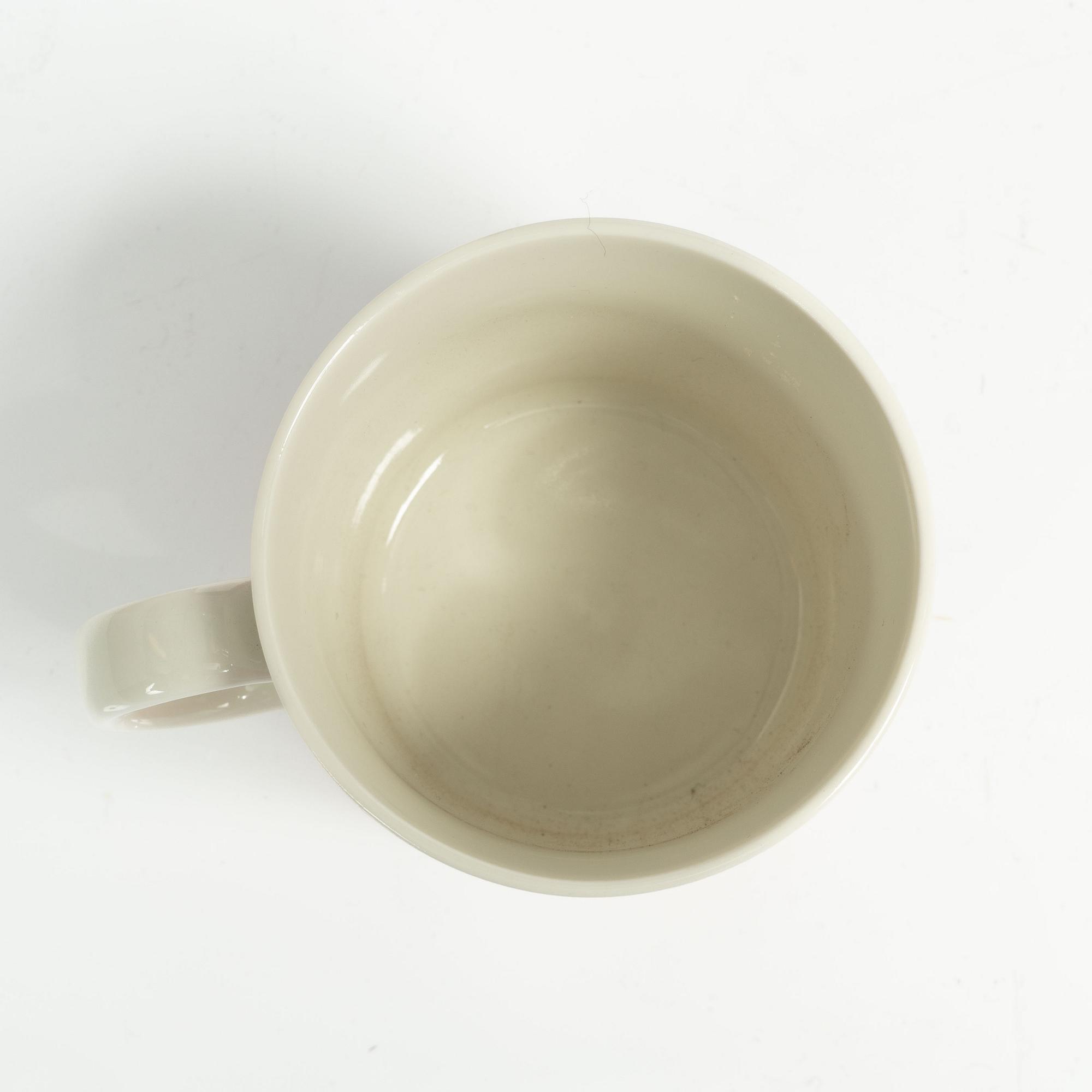 A Moomin mug, 'Dark rosa' with sticker, Arabia, Finland, 1991-99.