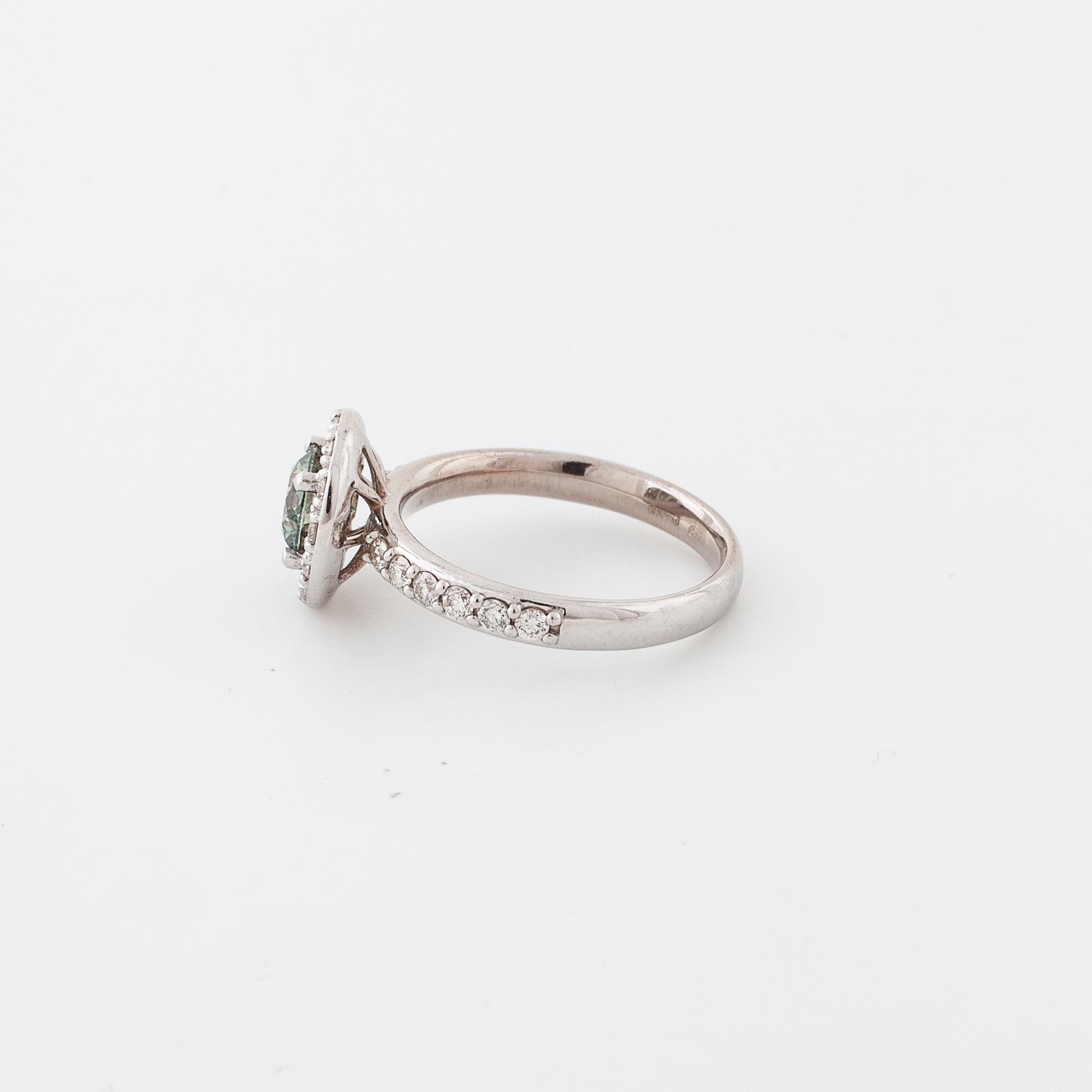 A treated green diamond and briliant cut diamonds.