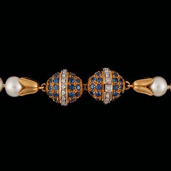 177. A cultured saltwater pearl, circa 8mm, necklace. Clasp designed as two eggs set with sapphires and diamonds.