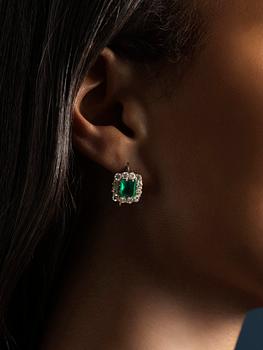 A pair of earrings in 18K gold set with step-cut emeralds and old-cut diamonds.