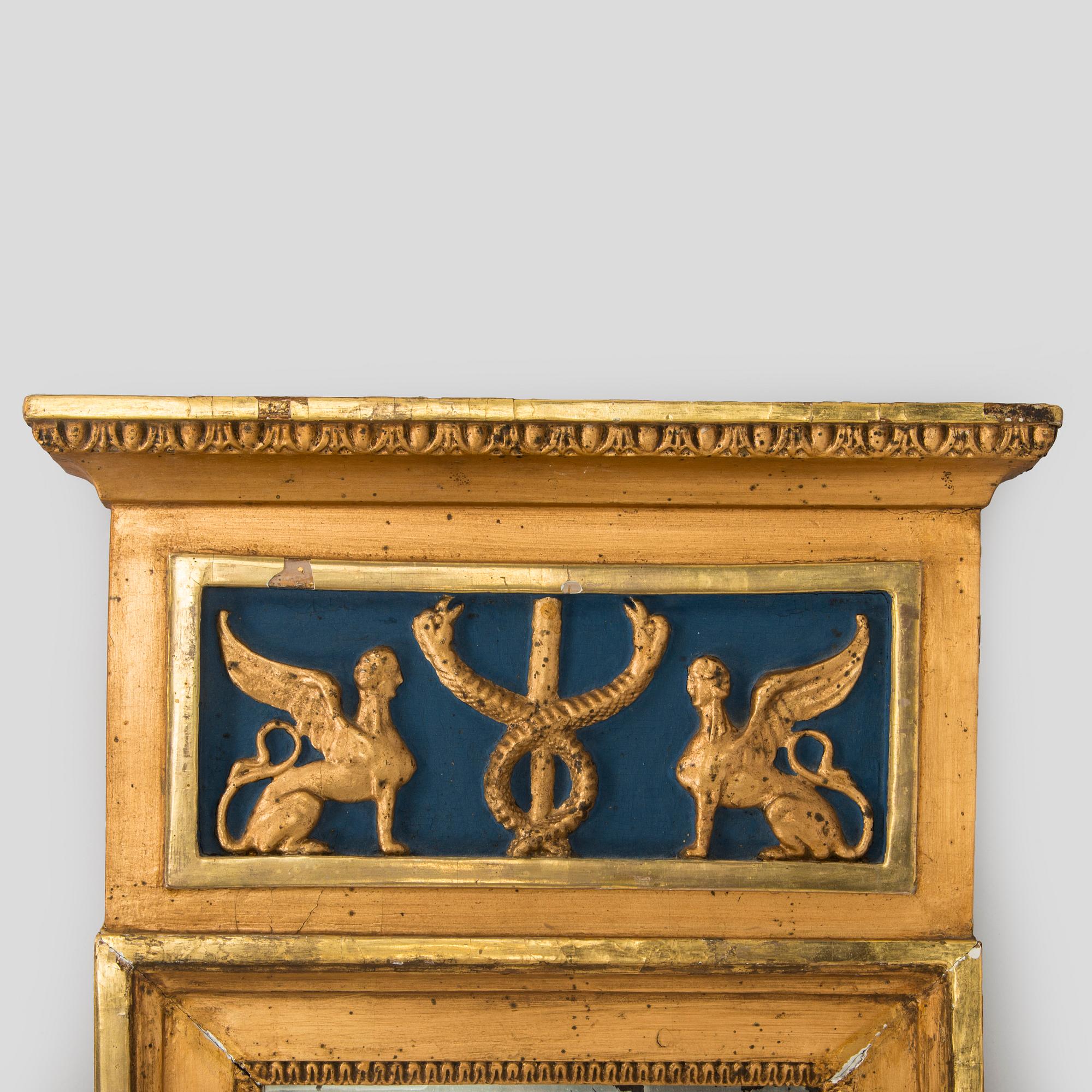 A gilded and bronzed Empire mirror, first half of the 19th century.