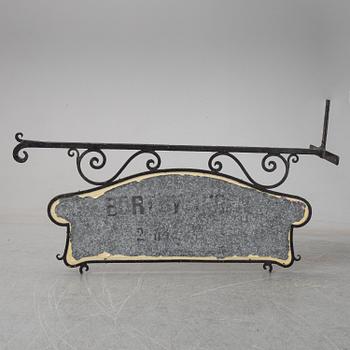 A wrought iron shop sign, 20th Century.