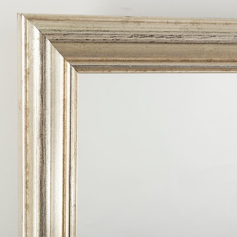 A large mirror in a silvered frame, 21 Century.