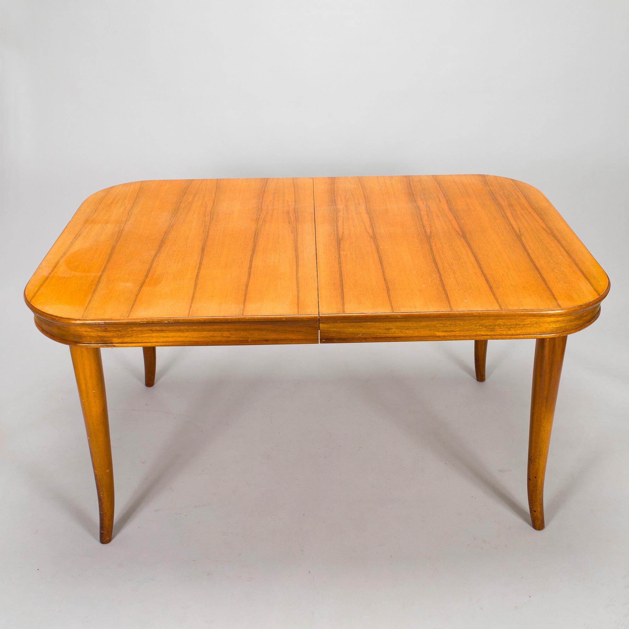 A mid 20th century dining table and a set of four chairs, Oy Boman Ab and two chairs Werner West.