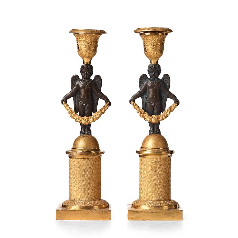 A pair of Empire early 19th century candlesticks.