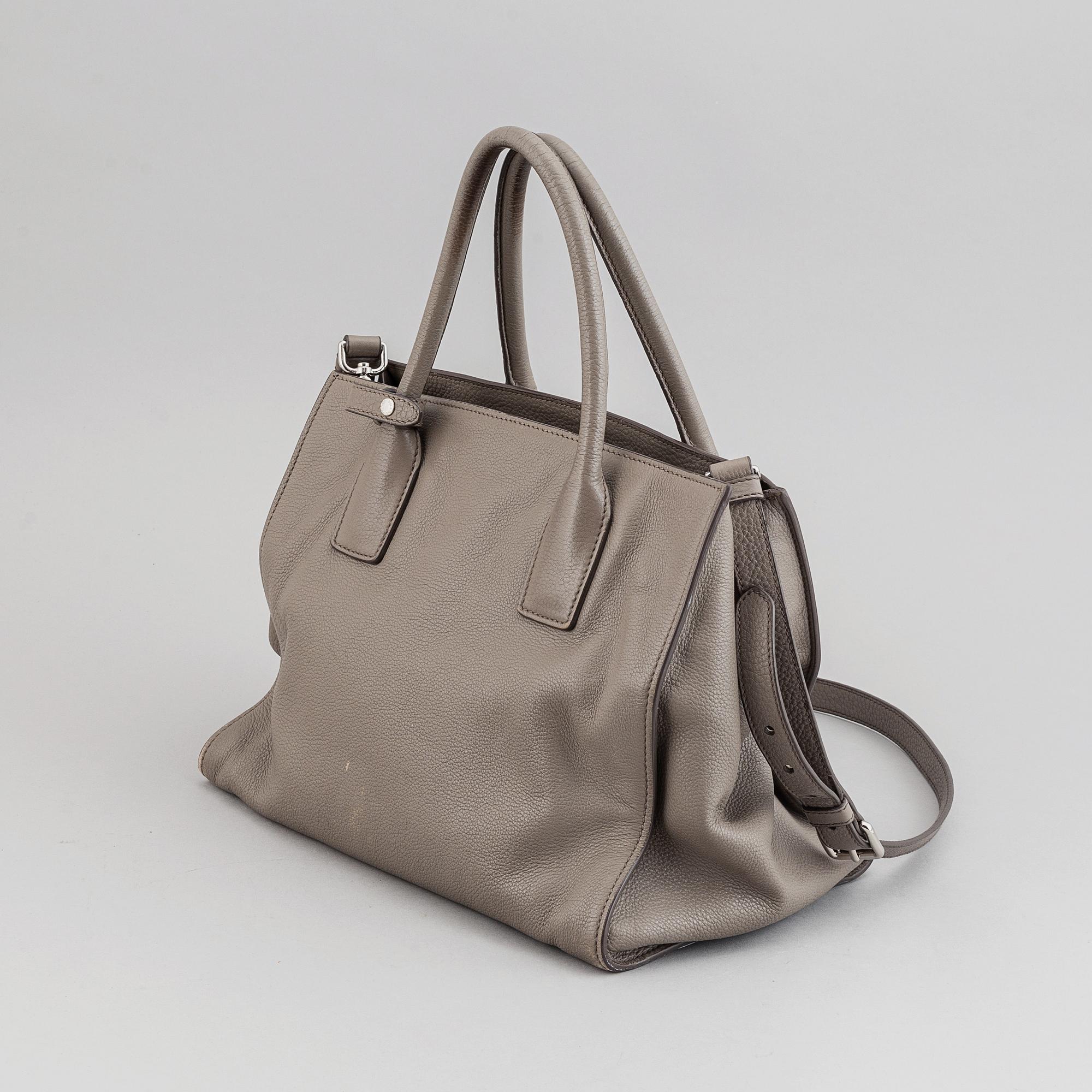 Prada, a leather handbag.