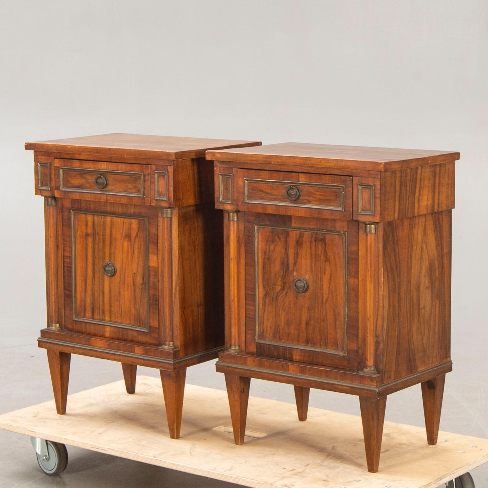 A pair of walnut Empire style bedside tables first half of the 20th century.