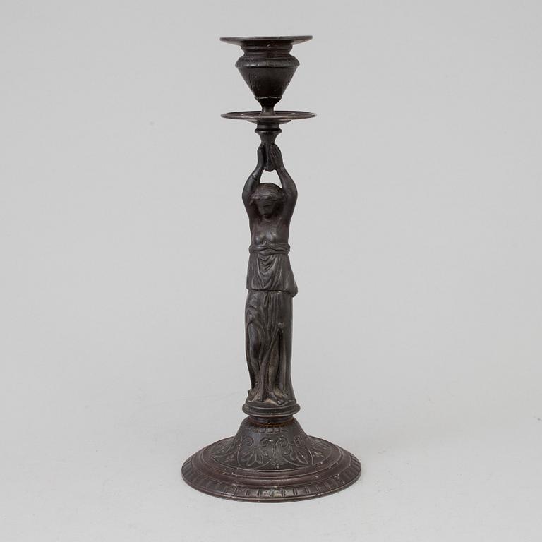 A 19th century iron candlestick marked F.L Vombach Offenbach A/M.