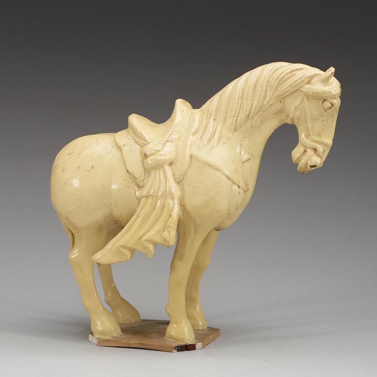 A yellow glazed pottery figure of a horze, presumably Tang dynasty (618-907).