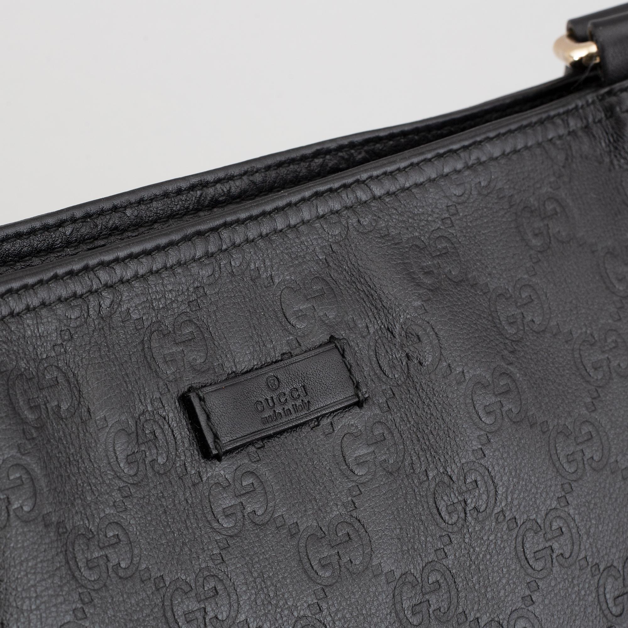 Gucci, a leather messenger bag.