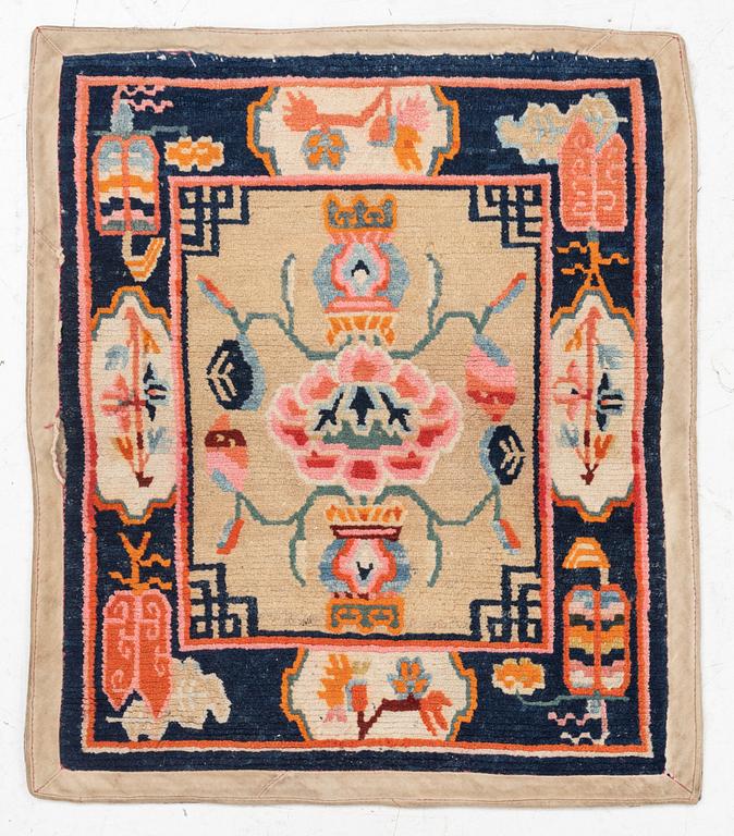 An antique Tibetian meditation rug, approximately 70 x 60 cm.