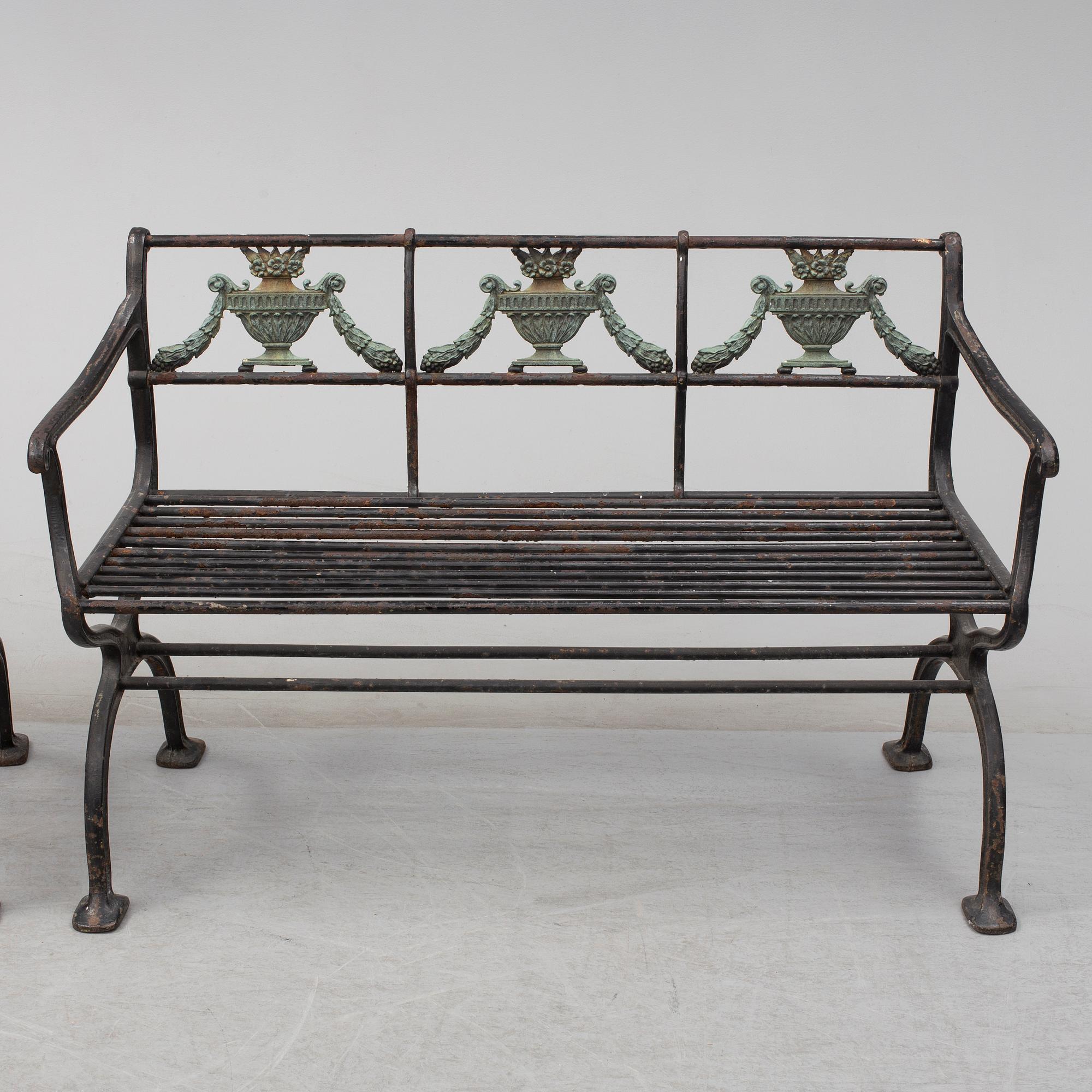 GARDEN SOFAS, a pair, cast iron, empire style, late 19th century.