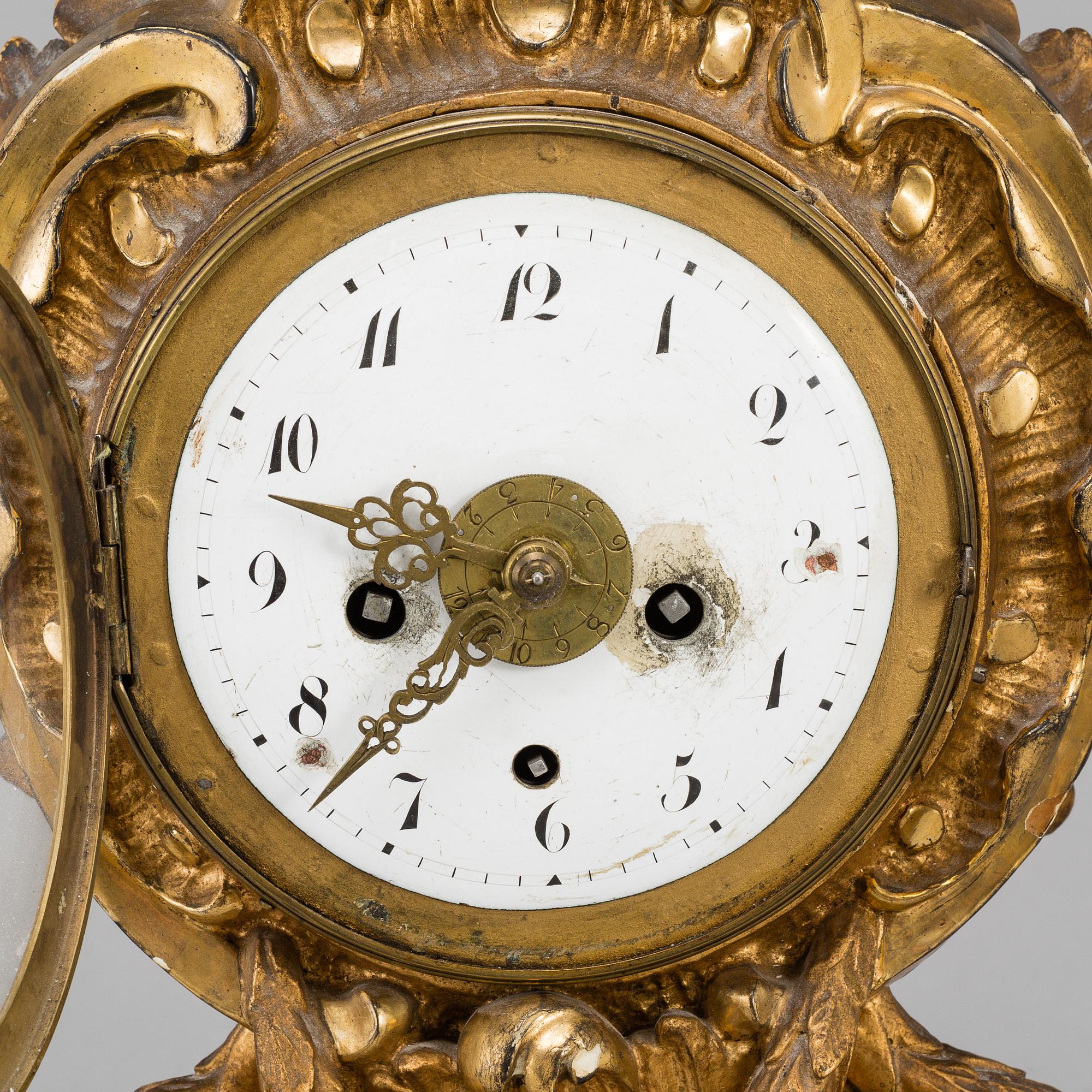 A swedish rococo gilt wood mantle clock.