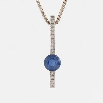 An 18K white gold necklace with a faceted sapphire and brilliant cut diamonds.