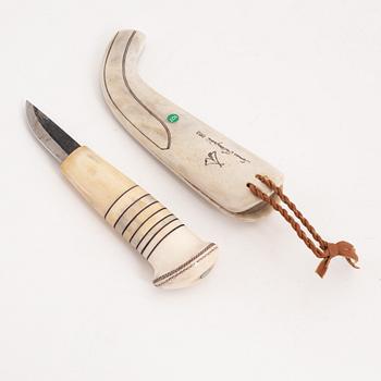 A reindeer horn knife by Tomas Valkeapää, signed and dated 1993.