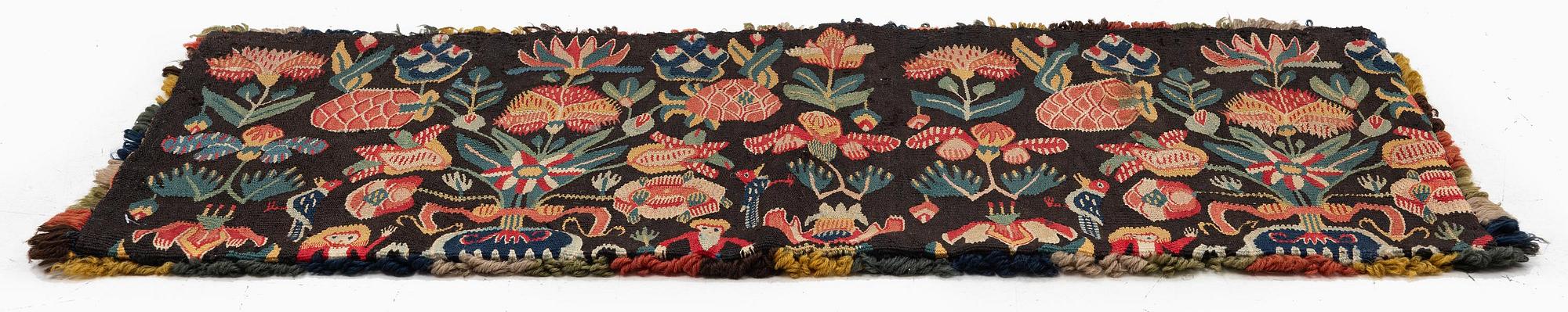 A carrige cushion, 'Urnor och par', tapestry weave, c. 82 x 39 cm, around the years 1800-1825.