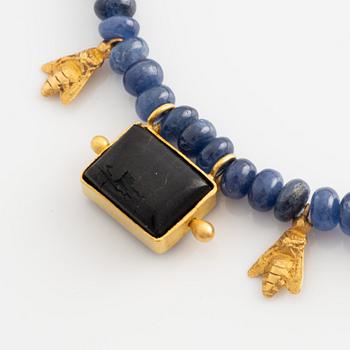 Necklace with sapphires and a black stone, details in 18K gold.