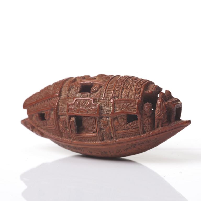 A Chinese nut boat sculpture, with poem.