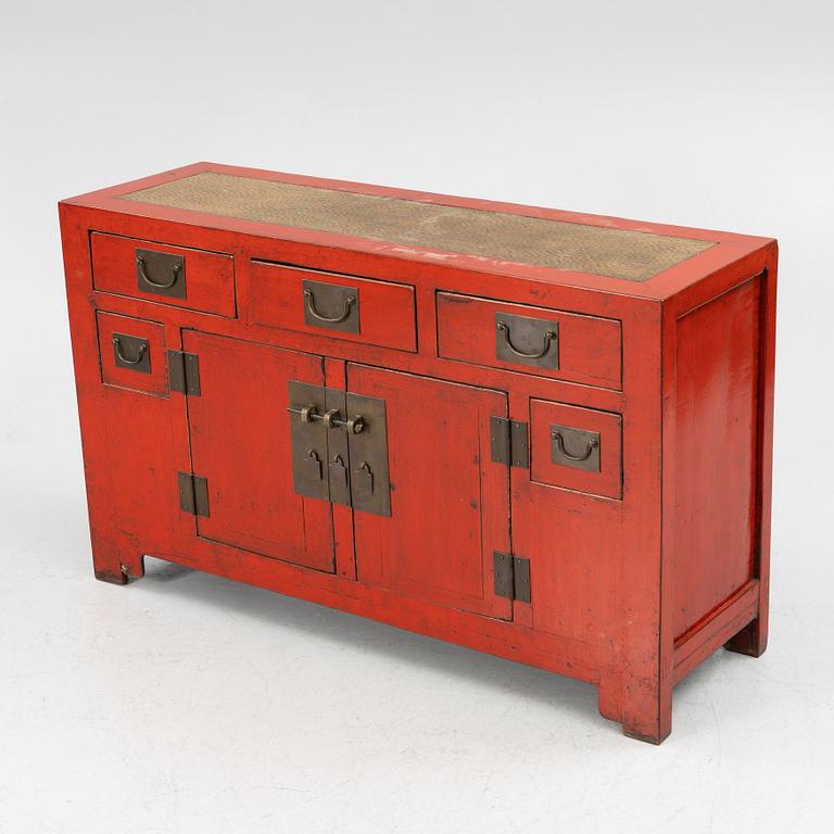 A Chinese red lacquered cabinet, 20th century.