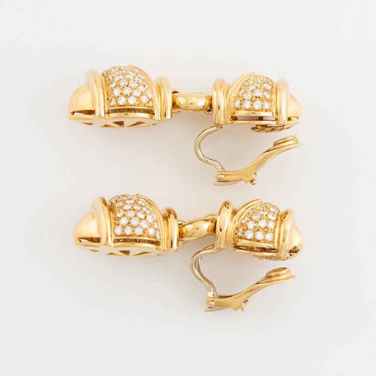 A pair of 18K gold earrings set with round brilliant-cut diamonds.