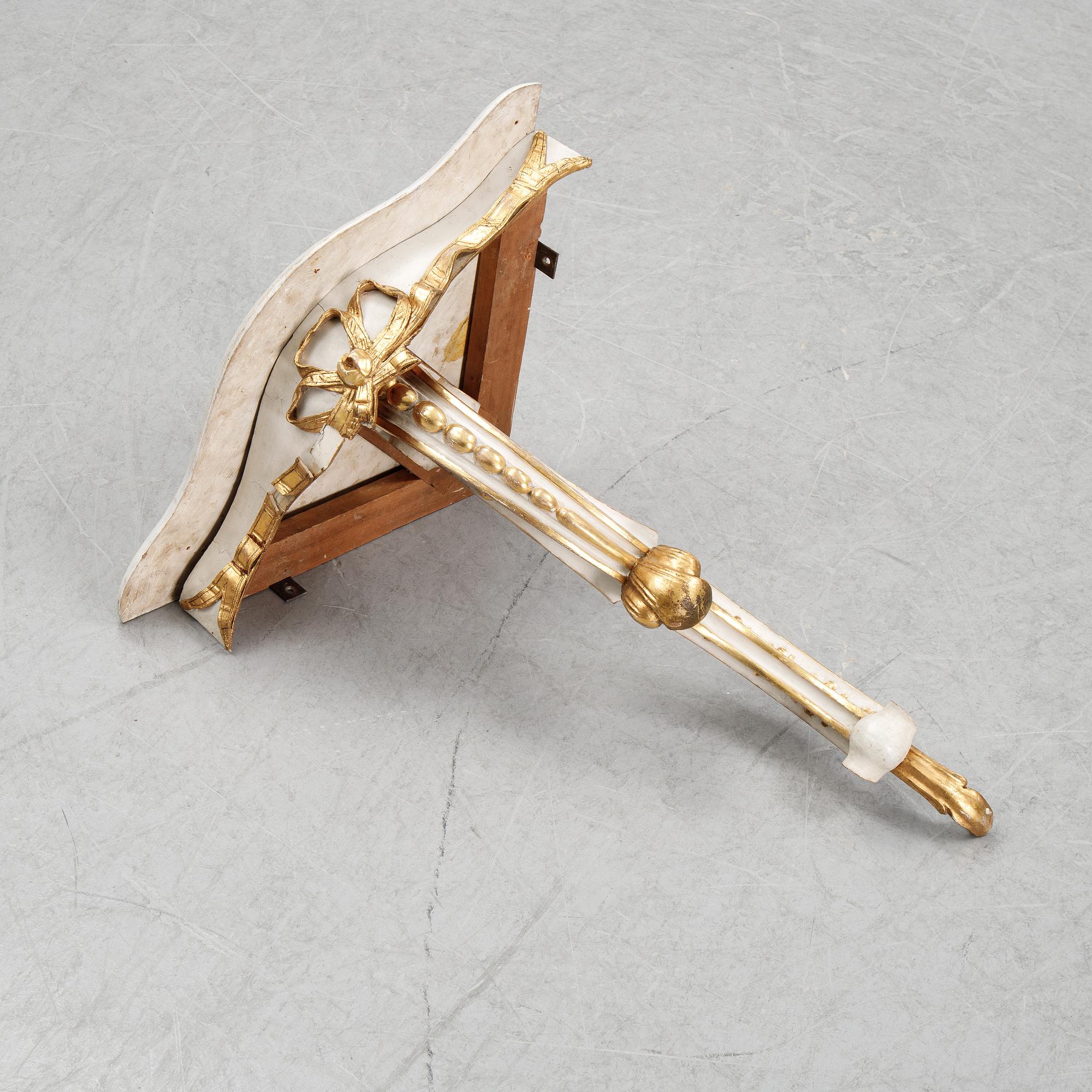 A samll console table for a corner with a wooden top.