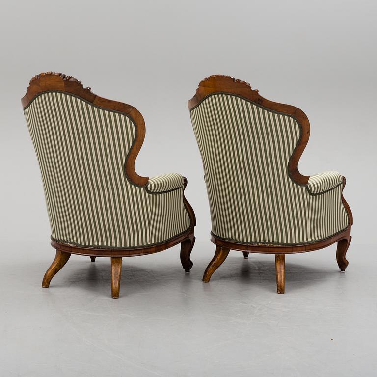 A pair of late 19th century rococo style easy chairs.