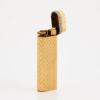 A cigarette lighter by Cartier set with single cut diamonds.
