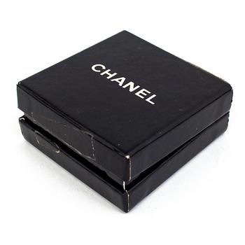 A pair of clips by Chanel.