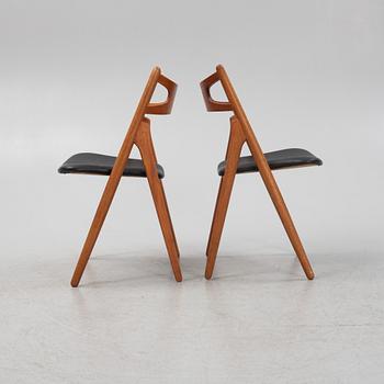 Hans J Wegner, a pair oak and teak CH29 'Savbukkestolen' chairs,Carl Hansen, mid 20th century.