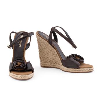 570. YVES SAINT LAURENT, a pair of straw and leather wedge sandals.