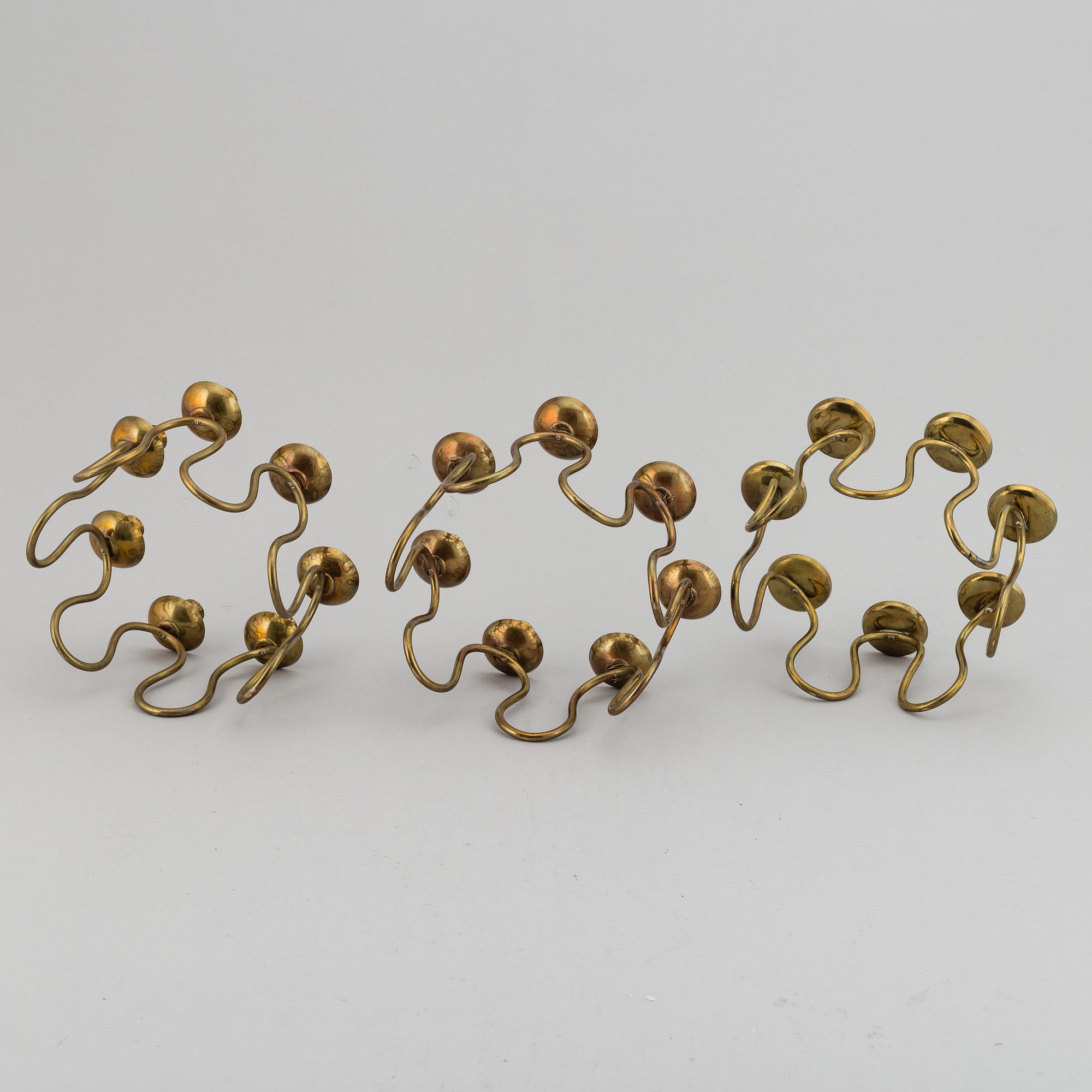 LARS HOLMSTRÖM, Three brass candelabra, Arvika, mid 20th Century.