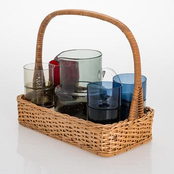 SAARA HOPEA, A glass pitcher and eight glasses in rattan basket, for Nuutajärvi. Designed year 1952.