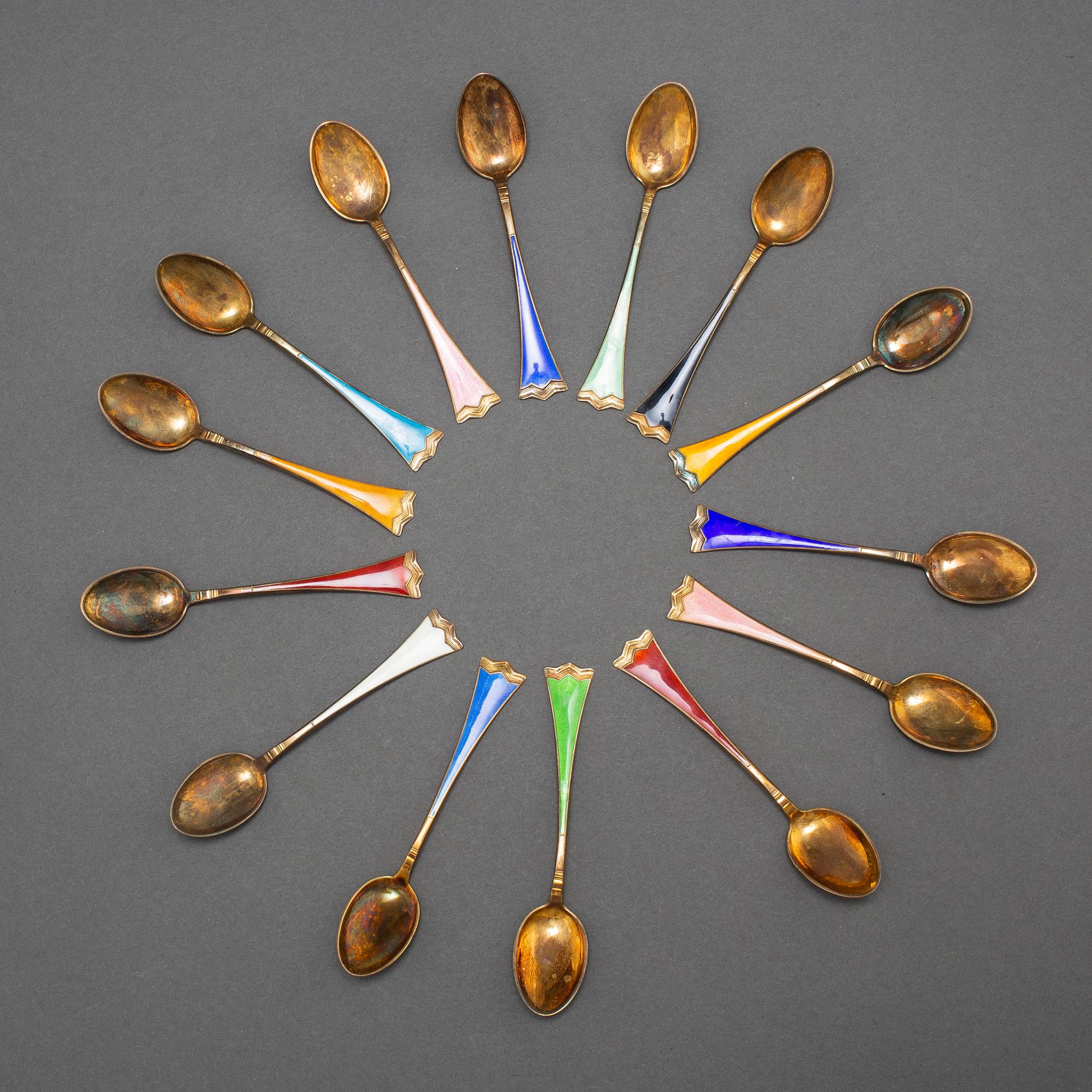 J TOSTRUP, 14 silver gilt and enamel coffee stoons from Oslo, Norway.