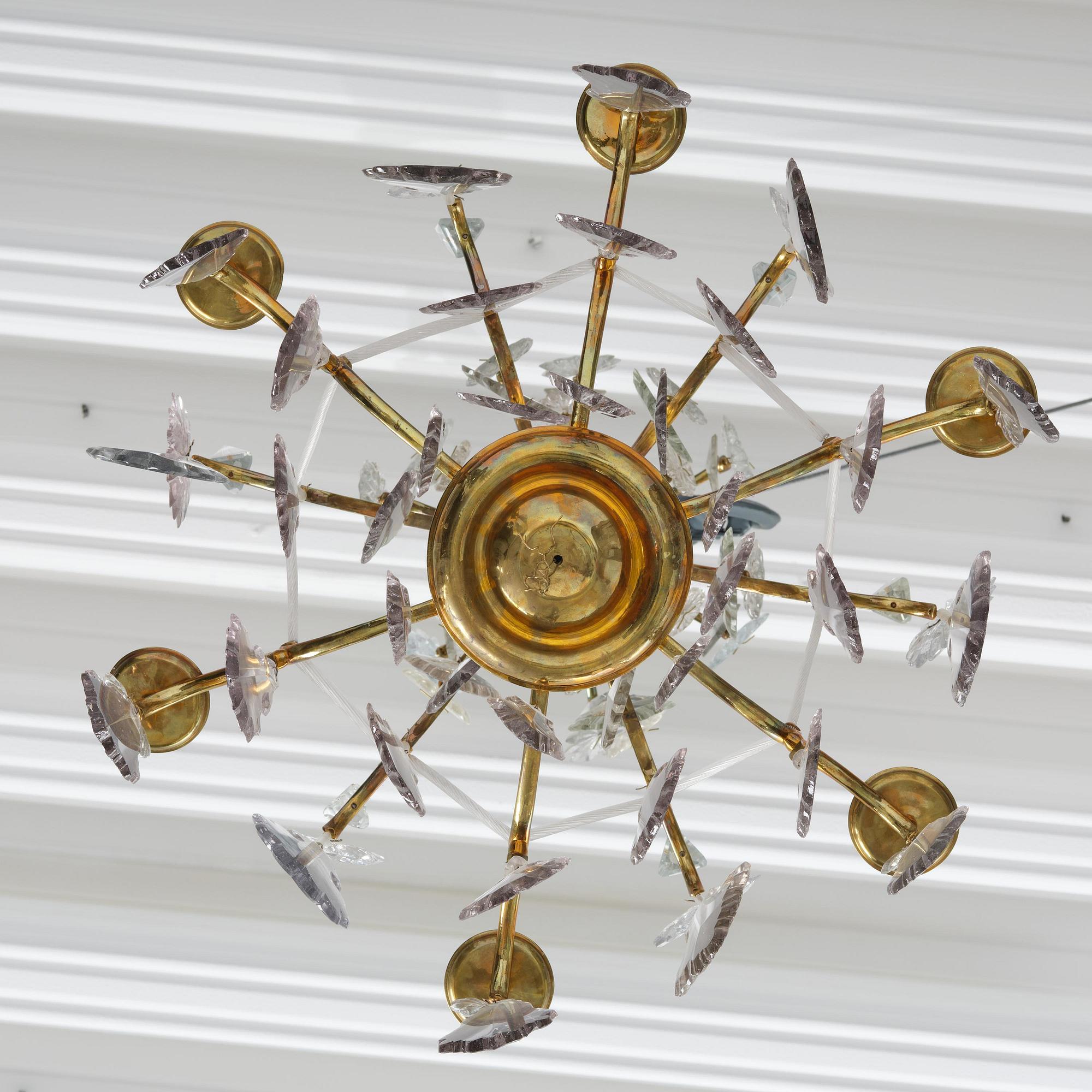 A near pair of rococo-style gilt brass and cut glass six-branch chandeliers, 19th century incorporating older elements.