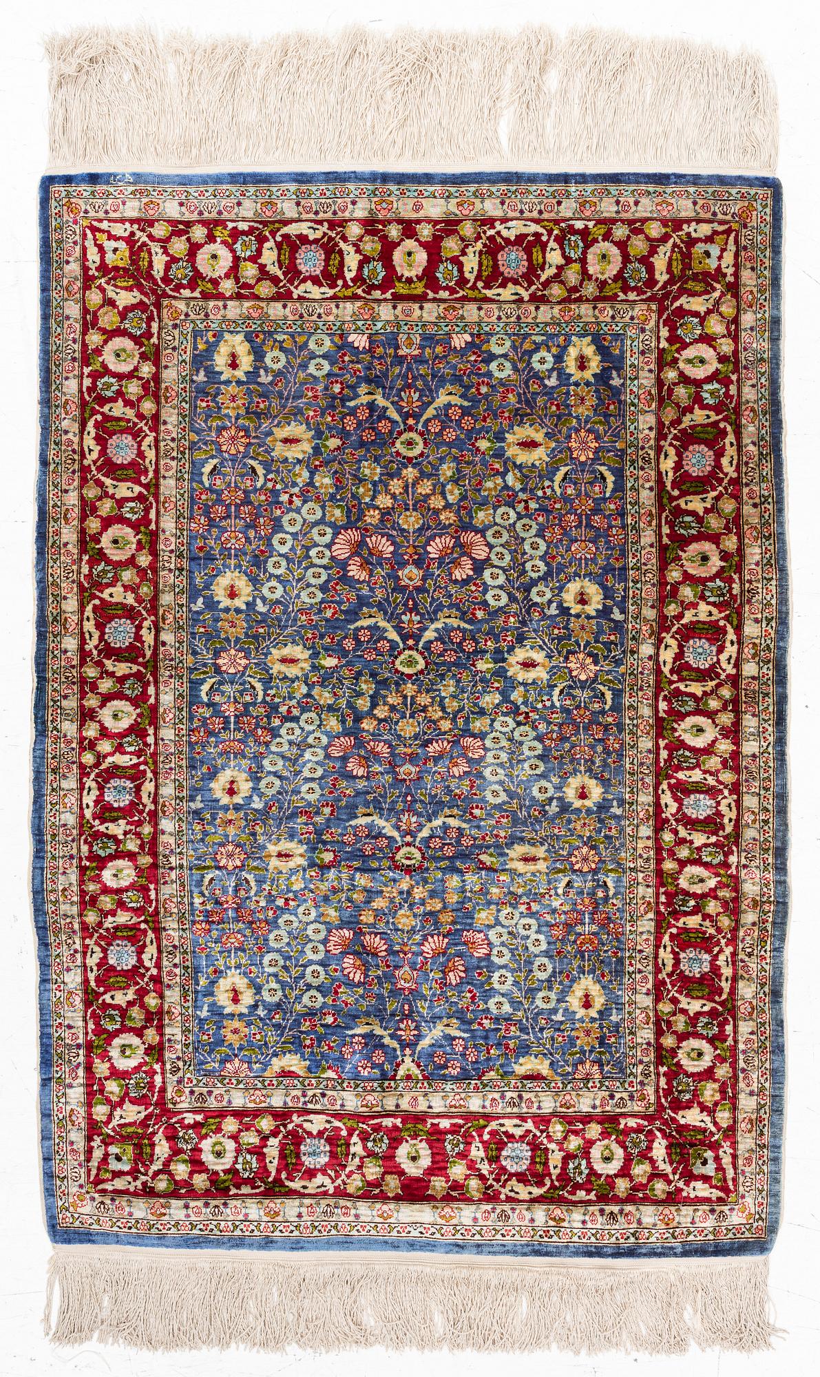 An Oriental silk rug, signed, c. 125 x 85 cm.
