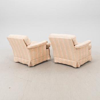 A pair of DUX 1960770s armchairs.