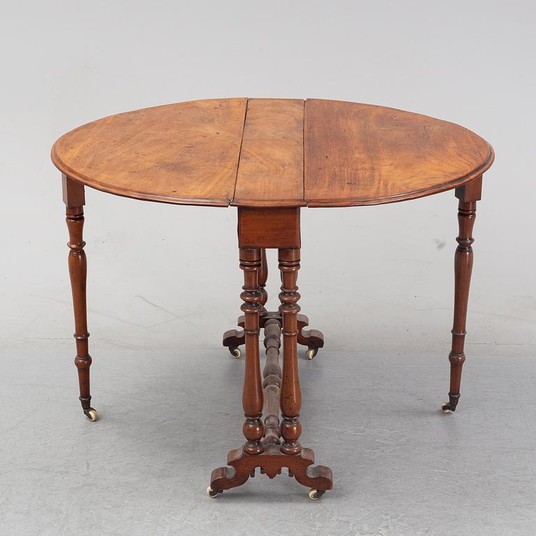 A neo-renaissance mahogany drop-leaf table from secord half of 19th century.