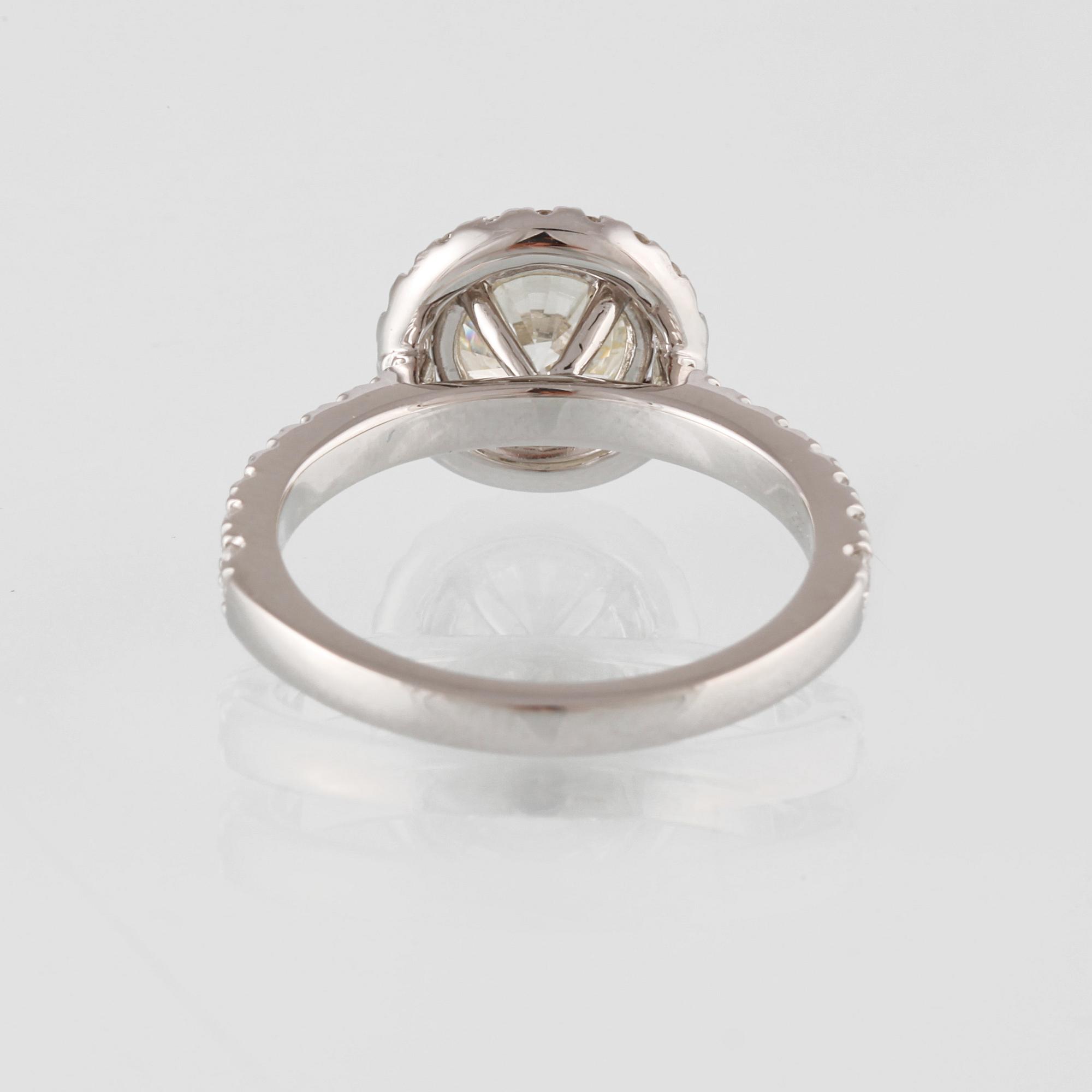 RING, 18K vitguld med en briljantslipad diamant 1.44 ct samt små briljantslipade diamanter 0.50 ct. Vikt 4,6 gram.