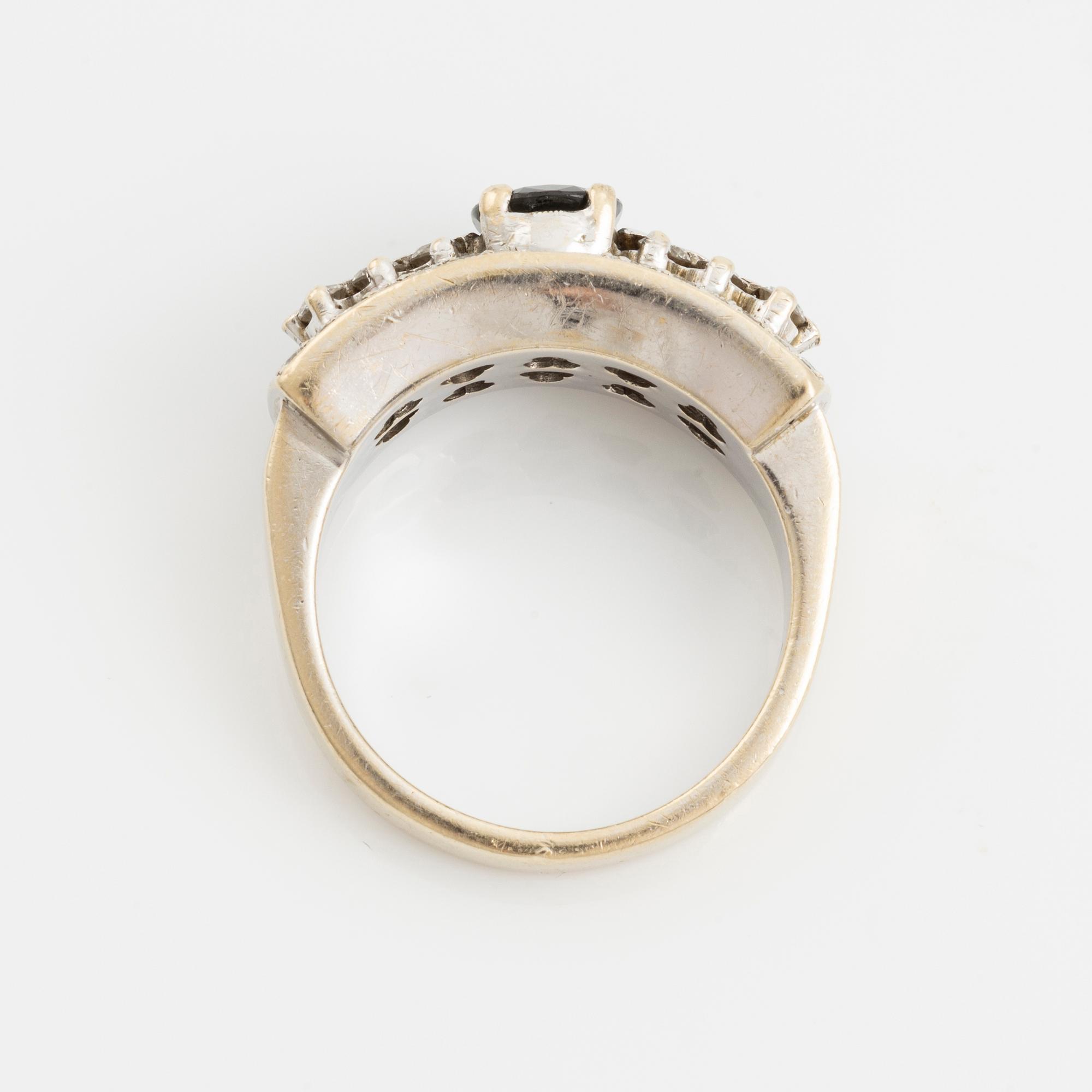 Ring with dark sapphire and brilliant-cut diamonds.