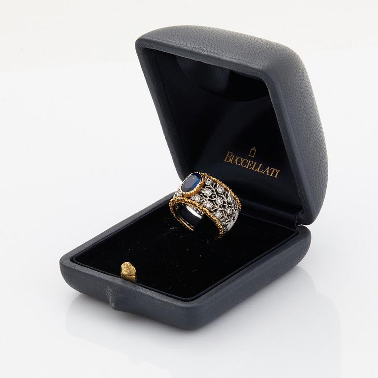 A Buccellati ring in 18K gold and white gold set with a faceted sapphire and round brilliant-cut diamonds.