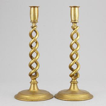 A pair of brass candle sticks. possibly English, circa 1900.