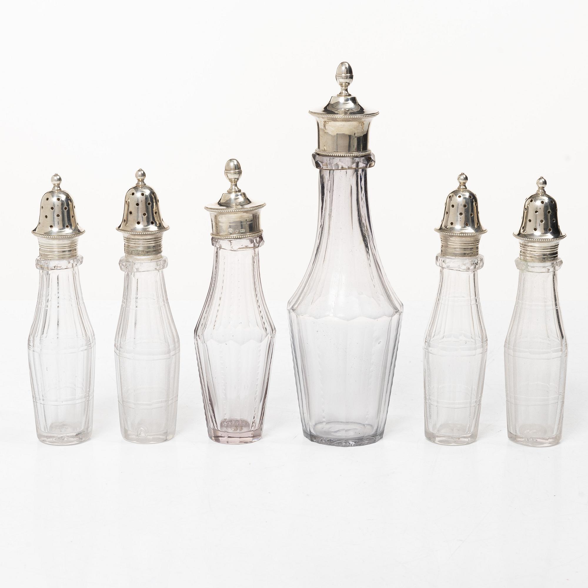 Parts for a table centrepiece, six glass bottles, and seven lids in silver, marked Pehr Zethelius, Stockholm 1807.