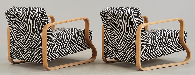 A pair of Alvar Aalto 'Padded Paimio' closed-framed armchairs, by O.y Huonekalu-ja Rakennustyötehdas A.B for Artek.