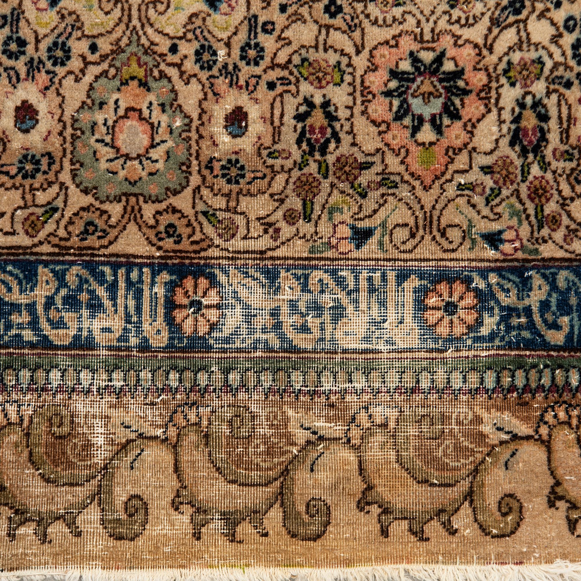 An antique Tabriz carpet, North West Persia, signed Akhondzadeh, c. 394 x 295 cm.