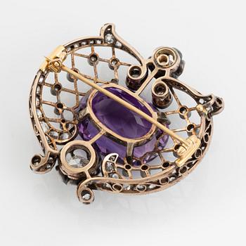 A brooch set with an amethyst and old-cut diamonds.