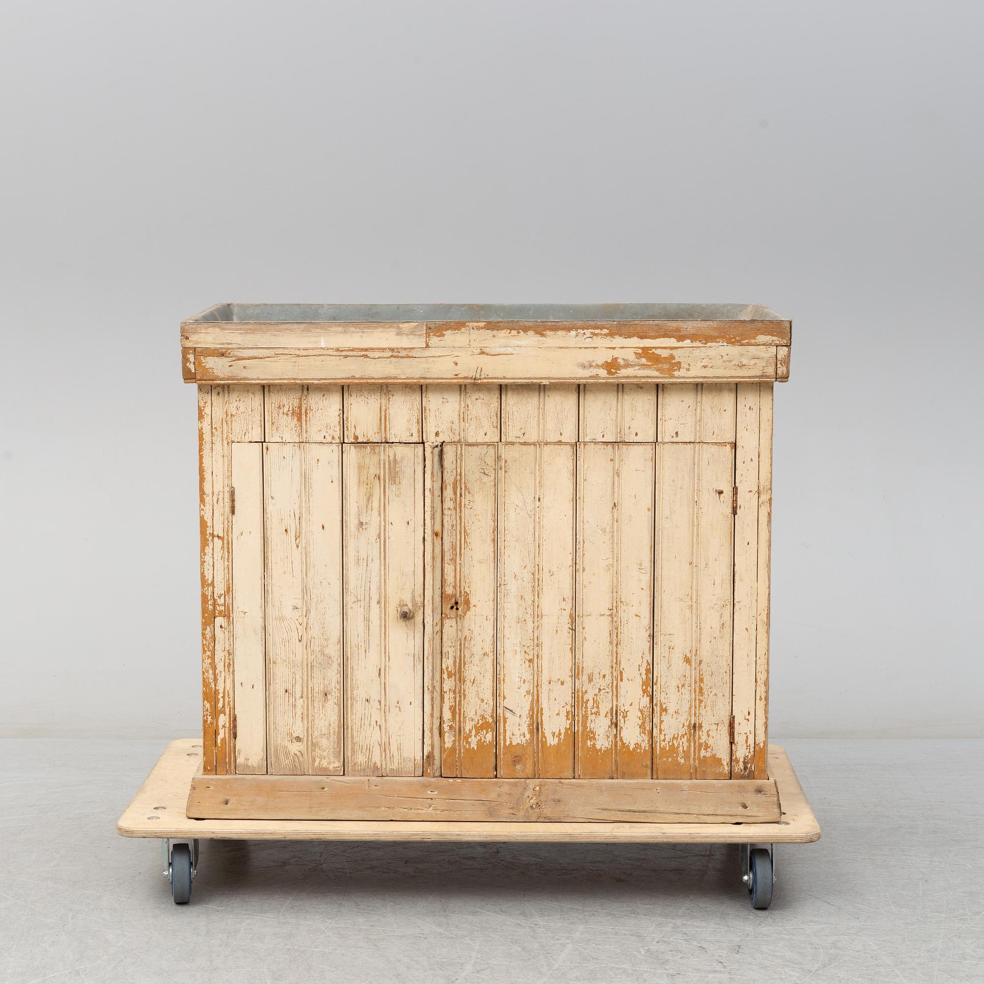 A late 19th Century cabinet with zink top.