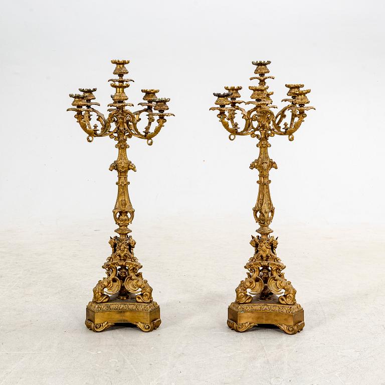 A pair of late 19th century metal candelabras.