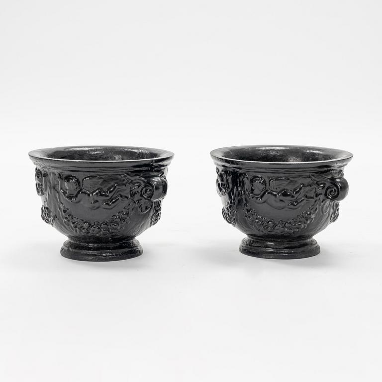 A pair of cast-iron urns.