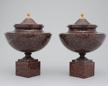 A pair of late Gustavian early 19th century porphyry urns with cover.